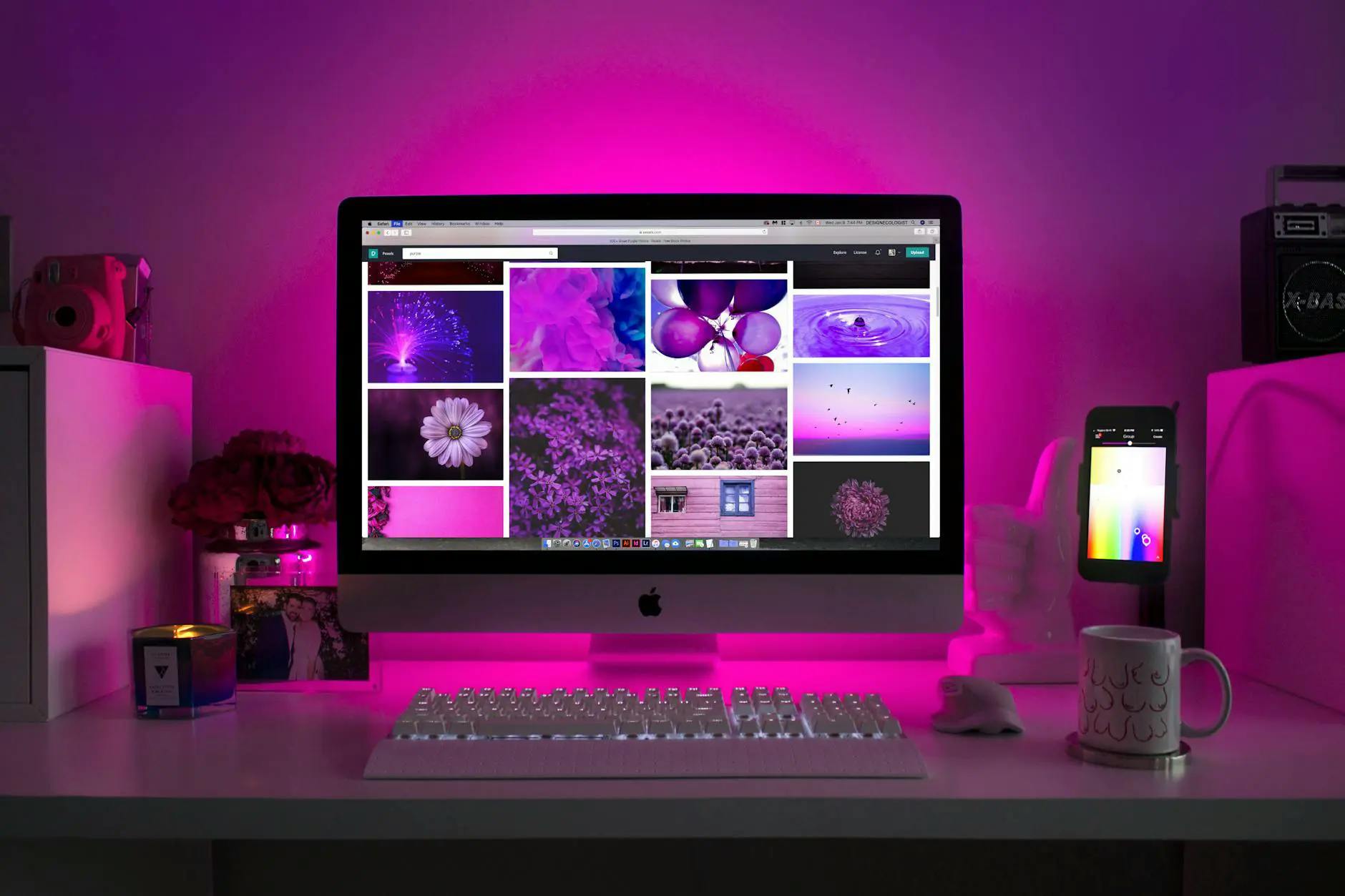 Computer in front of pink backlight
